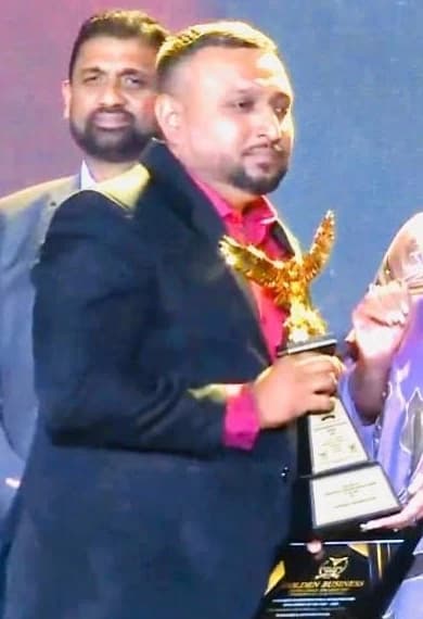 Mohamed Siraj Muneer holding the award at the Golden Business Excellence Awards 2025